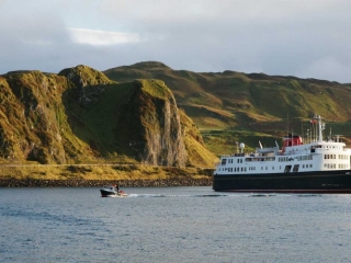 The Hebridean Princess moored on the shores of a Scottish Isle