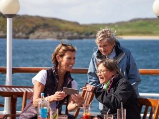 Guests enjoying each others company on the Promenade Deck on the Hebridean Princess cruise ship of Hebridean Island Cruises