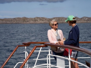 Two guests chatting on the Boat Deck on the Hebridean Princess cruise ship of Hebridean Island Cruises