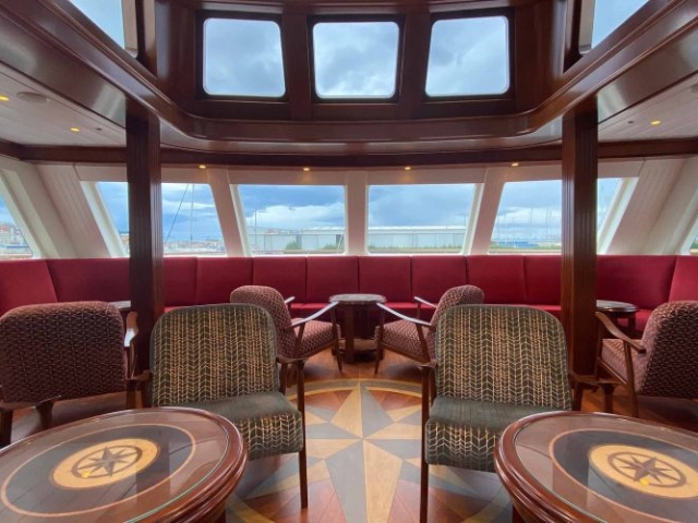 The luxury seating area in the lounge on the Lord of the Highlands cruise ship with views all around