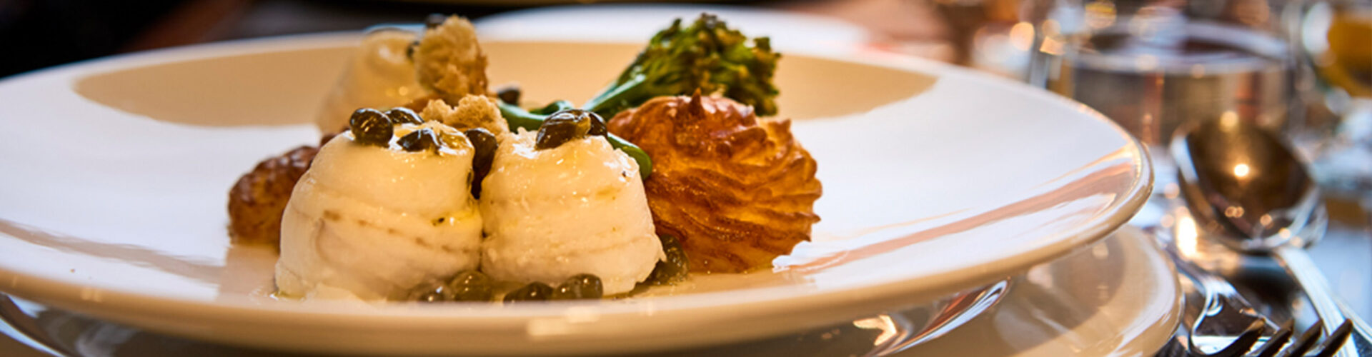 A plate of fine dining food on the Lord of the Highlands cruise ship