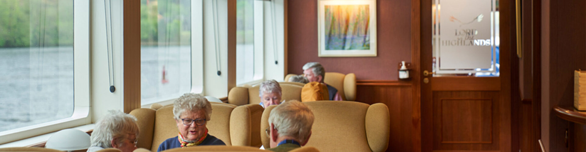 People relaxing in the Lord of the Highlands cruise ship lounge