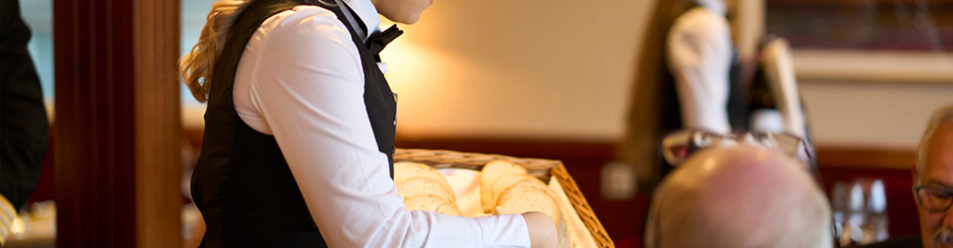 A waitress serving bread on the Lord of the Highlands cruise ship